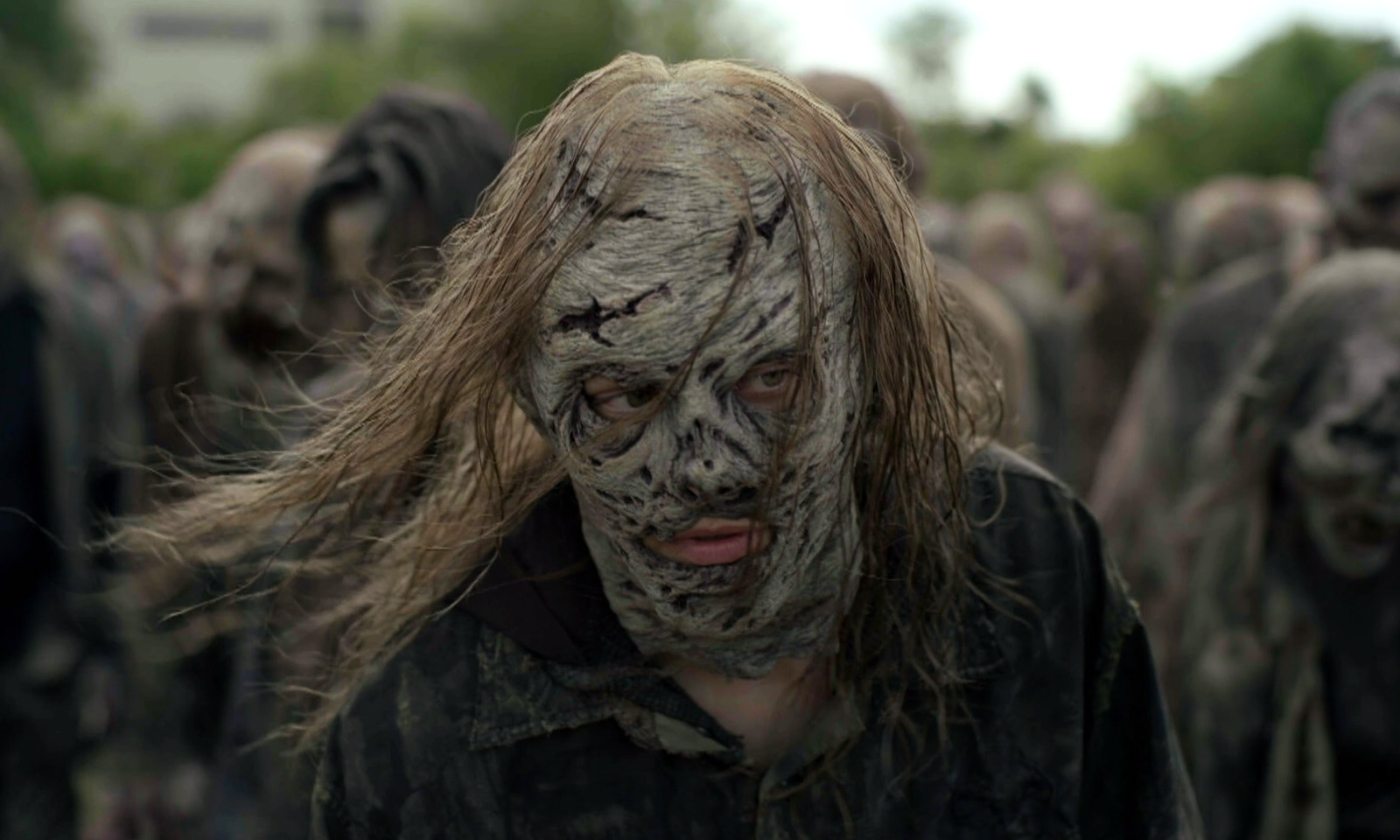 Maggie usando uma máscara de Sussurrador e andando em meio a uma horda de zumbis no episódio 7 da 11ª temporada de The Walking Dead.