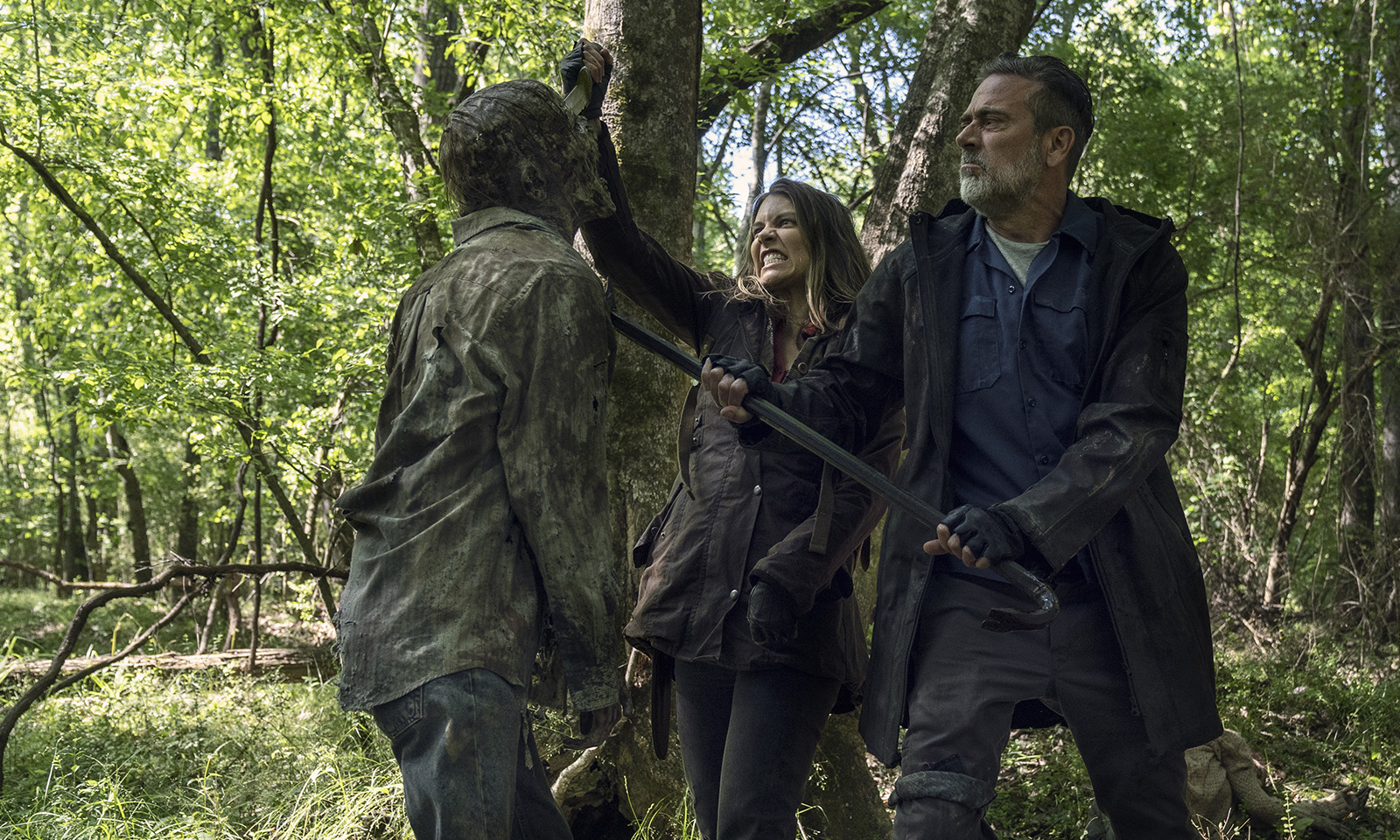 Maggie and Negan killing a zombie in a scene from season 11 of The Walking Dead.