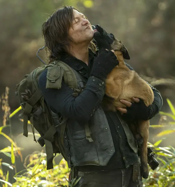 Daryl segurando o Dog e recebendo lambeijos em cena do episódio 18 da 10ª temporada de The Walking Dead.