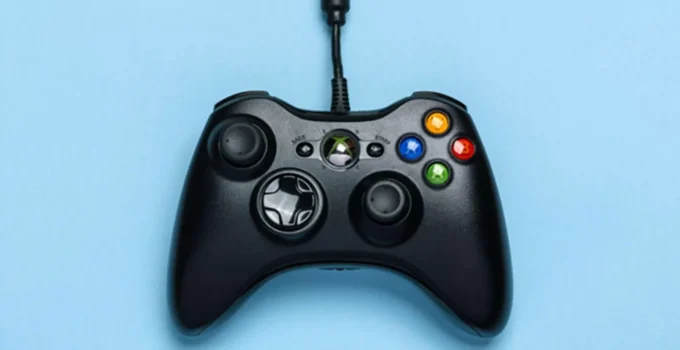 Imagem de um controle preto do XBOX One com fundo azul.
